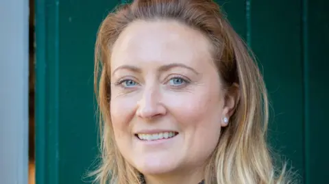 SimplyC Photography A smiling Lillie Pusey looking directly at the camera, with blonde hair and blue eyes. 