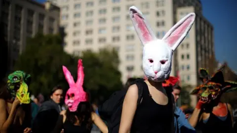 Reuters Demonstrators wear masks during a march demanding an end to sexism and gender violence in Santiago, Chile June 6, 2018.