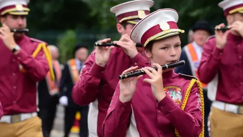 Pacemaker A girl plays a flute in a marching band at the Twelfth parade in Ballymena