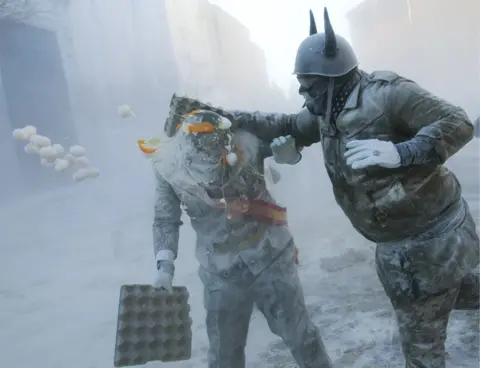 Jaime Reina / AFP Revellers throw flour and eggs at each other