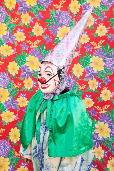 Lujan Agusti Portrait of clown in front of a patterned background