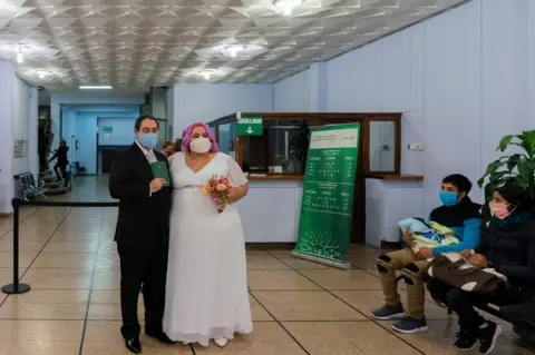 Matilde Campodónico Newlyweds pose for a photo after they were married at the civil registry office