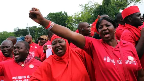Getty Images Members of Bring Back Our Girls group with fists up during a march