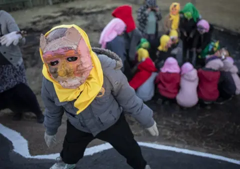 EPA Costumed children from the local Shade performance group perform their show during the annual Brixton Burn in Johannesburg, South Africa, 28 August 2021. The annual event is run by members of the "Afrikaburn" community which is a regional event of "Burning Man" in the United States.