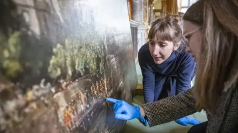 National Trust/James Dobson Two women looking at The Embarkation of George IV from Whitehall: the Opening of Waterloo Bridge, 1817, by John Constable