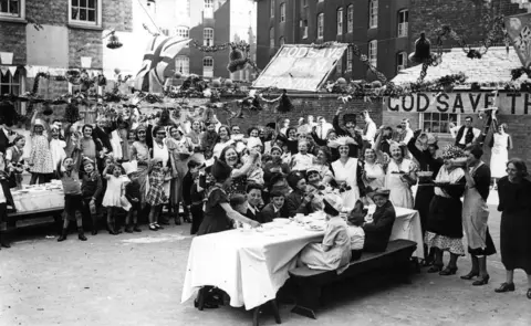 Getty Images 6th May 1935: A children's party to celebrate the Silver Jubilee of King George V at Tregenna Street, Brixton, south London.