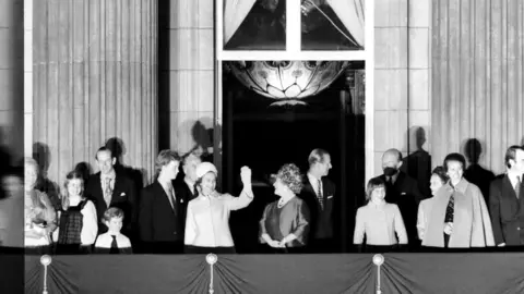 Getty Images Her Majesty Queen Elizabeth II and Prince Philip, Duke of Edinburgh waving to the crowd from Buckingham Palace with other members of the Royal family. June 1977