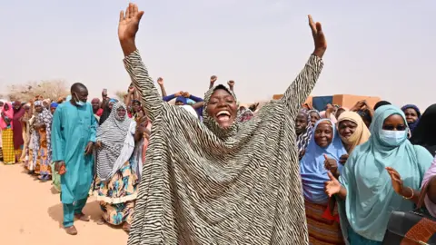 AFP A woman raises her hands in welcome in an IDP camp in Ouallam, Niger - Tuesday 3 May 2022