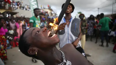 EPA A fire eater performing at a carnival in Bonoua, Ivory Coast - 30 April 2022