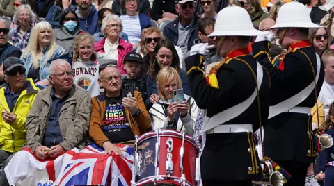 PA Media Crowds watch as the Band of Her Majesty's Royal Marines Scotland plays in Princess Street Gardens in Edinburgh during a Platinum Jubilee event on day four of the Platinum Jubilee celebrations.