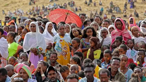 AFP Ethiopian refugees gather to celebrate the 46th anniversary of the Tigray People's Liberation Front at Um Raquba refugee camp in Gedaref, eastern Sudan, on February 19, 2021.