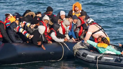 AFP Migrants are rescued by crew members of the Abeille Languedoc ship after their boat's generator broke down in French waters while they were trying to cross the Channel illegally to Britain, off the coasts of Boulogne-sur-Mer, northern France, on May 9, 2022
