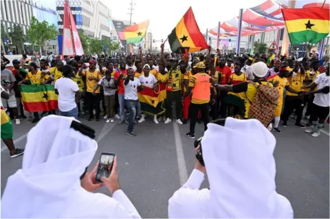 AFP Ghana fans on the streets as Qatari people take pictures of them.
