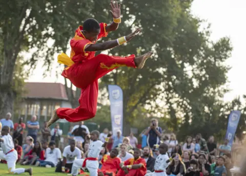 Ihsaan Haffejee/Getty Images Someone jumping at Chinese Lunar New Year event in Johannesburg, South Africa - Saturday 4 February 2023