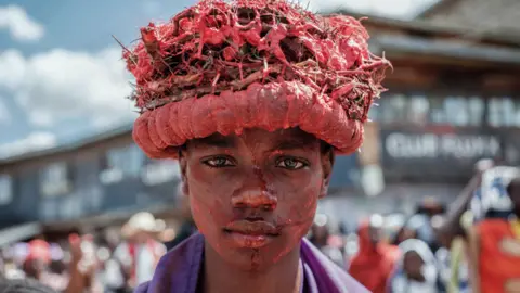 Yasuyoshi Chiba/AFP Brolyne Befany Joseph plays the role of Jesus Christ during a Passion of the Christ re-enactment by worshippers of Our Lady of Lourdes Catholic Church during their Good Friday procession through the streets of Kibera slum, Nairobi, Kenya - 7 April 2023