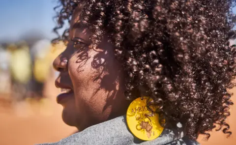 Zinyange Auntony/AFP A woman wearing African queen earrings in Sibombvu village outside Bulawayo, Zimbabwe - 23 July 2023