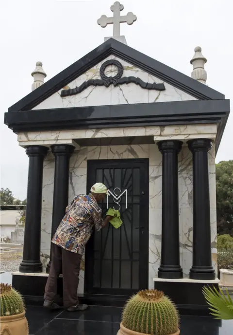 AFP A man cleans the tomb of Mobutu Sese Seko, the late dictator of the self-styled "King of Zaire", which was later renamed the Democratic Republic of Congo after his overthrow, in the European cemetery in Rabat on September 3, 2017, four days before the 20th anniversary of his death. Mobutu died on September 7, 1997 at the Mohamed V military hospital in Rabat after a long battle with prostate cancer. Twenty years on from his death in exile in Morocco, the simple initials MSS on a family grave mark the resting place of Mobutu Sese Seko, the self-styled "King of Zaire".
