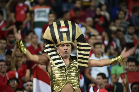 AFP Egyptian fans cheer for their national team during the FIFA World Cup 2018 qualification football match between Egypt and Uganda at the Borg al-Arab Stadium near Alexandria on September 5, 2017.