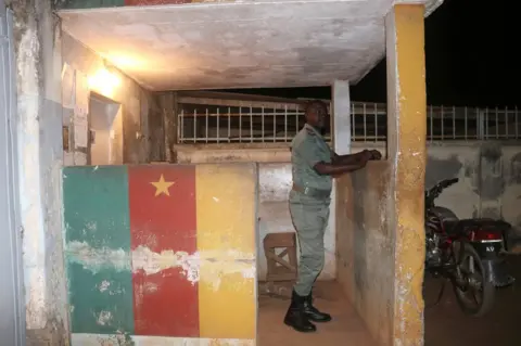 Reuters A security forces member stands in guard during the release of Anglophone activists at the prison of Yaounde,Cameroon, September 1, 2017.