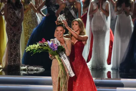 AFP Miss South Africa 2017 Demi-Leigh Nel-Peters (L) reacts as she is crowned new Miss Universe 2017 by Miss Universe 2016 Iris Mittenaere November 26, 2017 in Las Vegas, Nevada Beauties from across the globe converged in Las Vegas Sunday, where Miss South Africa was crowned Miss Universe. Demi-Leigh Nel-Peters, 22, edged out her rivals from Colombia and Jamaica to take the crown. Nel-Peters, a graduate in business management, said her disabled half-sister has been among her great inspirations.