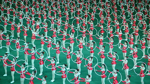 A routine for young women involves a dizzying display of mass movement with hula hoops.