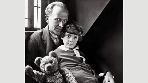 Pictorial Press Ltd/Alamy Milne with his son Christopher and the well-loved bear in 1926 (Credit: Pictorial Press Ltd/Alamy)