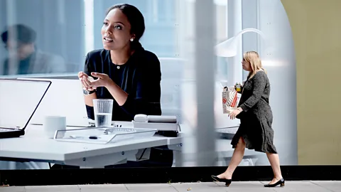 Getty Images Woman Walks Past Leadership Ad Lunch Break