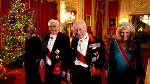 PA Media The German president and his wife at the state banquet with the King and Queen
