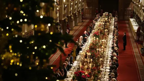 PA Media Guests line both sides of a long, mahogany table stretches the length of St George's Hall
